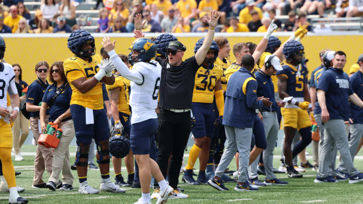 Former West Virginia specialist Pat McAfee celebrates after a conversion during competition drills in the 2024 Gold-Blue Spring Game. 