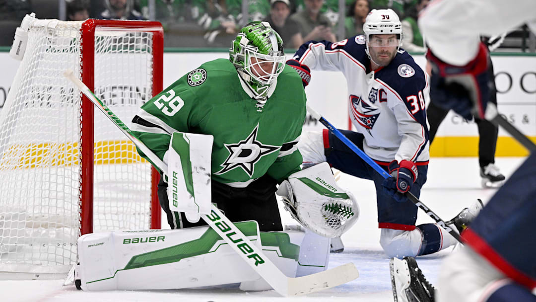 Oct 21, 2025; Dallas, Texas, USA; Columbus Blue Jackets center Boone Jenner (38) scores a power play goal against Dallas Stars goaltender Jake Oettinger (29) during the first period at the American Airlines Center. Mandatory Credit: Jerome Miron-Imagn Images