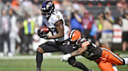 Oct 1, 2023; Cleveland, Ohio, USA; Baltimore Ravens running back Justice Hill (43) runs with the ball beside Cleveland Browns safety Grant Delpit (22) in the second quarter at Cleveland Browns Stadium. Mandatory Credit: David Richard-Imagn Images