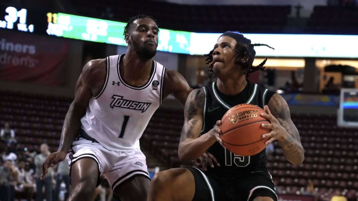 Nov 19, 2023; Charleston, SC, USA; Towson Tigers forward Tomiwa Sulaiman (1) defends against North Texas Mean Green guard Rubin Jones (15) in the second half at TD Arena. Mandatory Credit: David Yeazell-USA TODAY Sports