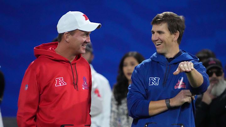 Peyton Manning and Eli Manning talk during the NFL Pro Bowl.