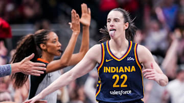 Indiana Fever guard Caitlin Clark (22) high-fives fans after scoring a 3-pointer Saturday, June 14, 2025, during a game between the Indiana Fever and the New York Liberty at Gainbridge Fieldhouse in Indianapolis.