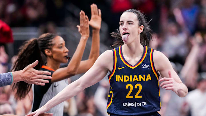 Indiana Fever guard Caitlin Clark (22) high-fives fans after scoring a 3-pointer Saturday, June 14, 2025, during a game between the Indiana Fever and the New York Liberty at Gainbridge Fieldhouse in Indianapolis. Indiana Fever guard Caitlin Clark (22) high-fives fans after scoring a 3-pointer Saturday, June 14, 2025, during a game between the Indiana Fever and the New York Liberty at Gainbridge Fieldhouse in Indianapolis.