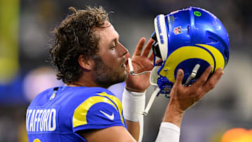 Nov 24, 2024; Inglewood, California, USA;  Los Angeles Rams quarterback Matthew Stafford (9) puts on his helmet during warmups before a game against the Philadelphia Eagles at SoFi Stadium. Mandatory Credit: Alex Gallardo-Imagn Images