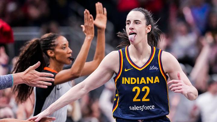 Indiana Fever guard Caitlin Clark (22) high-fives fans after scoring a 3-pointer Saturday, June 14, 2025, during a game between the Indiana Fever and the New York Liberty at Gainbridge Fieldhouse in Indianapolis.