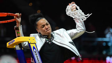 South Carolina basketball coach Dawn Staley cutting down the nets after her third National Championship
