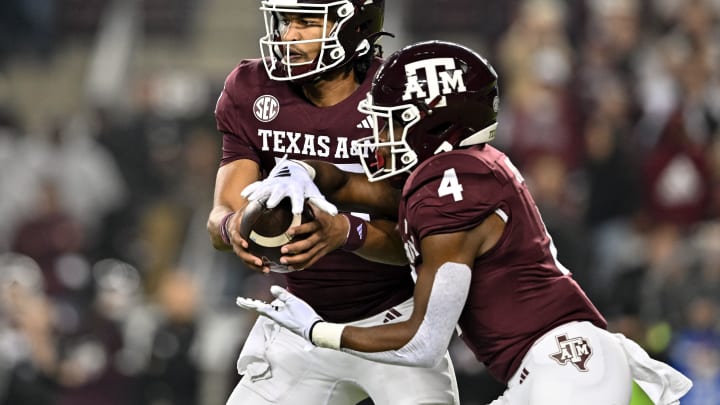 Nov 11, 2023; College Station, Texas, USA; Texas A&M Aggies quarterback Jaylen Henderson (16) hands off the ball to running back Amari Daniels (4) during the first quarter at Kyle Field. Mandatory Credit: Maria Lysaker-USA TODAY Sports