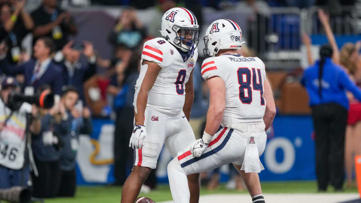 Dec 28, 2023; San Antonio, TX, USA; Arizona Wildcats running back DJ Williams (8) celebrates a touchdown with tight end Tanner McLachlan (84) in the second half against the Oklahoma Sooners at Alamodome