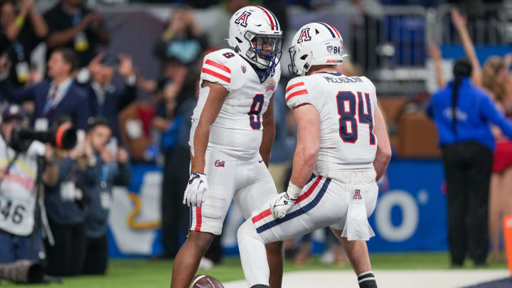 Dec 28, 2023; San Antonio, TX, USA; Arizona Wildcats running back DJ Williams (8) celebrates a touchdown with tight end Tanner McLachlan (84) in the second half against the Oklahoma Sooners at Alamodome