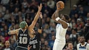 Minnesota Timberwolves guard Anthony Edwards shoots over San Antonio Spurs forward Jeremy Sochan (10) and guard Stephon Castle in the first half at Target Center in Minneapolis on March 9, 2025. 