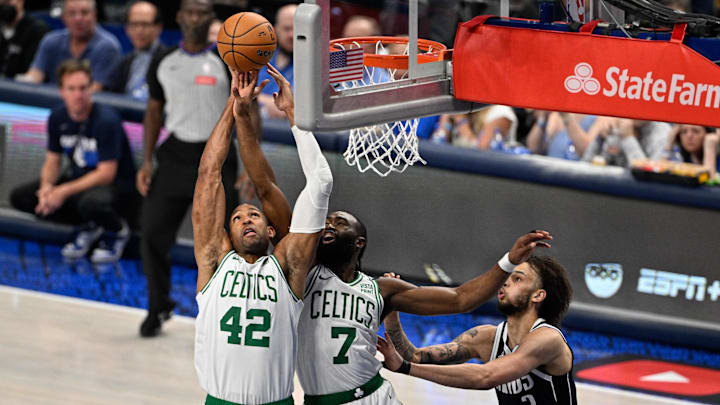Boston Celtics center Al Horford and guard Jaylen Brown go for a rebound against the Dallas Mavericks.