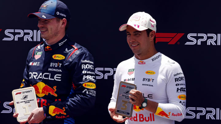 May 4, 2024; Miami Gardens, Florida, USA; Red Bull Racing driver Max Verstappen (1) poses with first place trophy and Red Bull Racing driver Sergio Perez (11) poses with the third place trophy the after winning the F1 Sprint Race at Miami International Autodrome. Mandatory Credit: Peter Casey-USA TODAY Sports