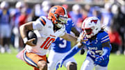 Oct 4, 2025; Dallas, Texas, USA; Syracuse Orange quarterback Rickie Collins (10) stiff arms SMU Mustangs safety Isaiah Nwokobia (23) during the first half at Gerald J. Ford Stadium. Mandatory Credit: Jerome Miron-Imagn Images