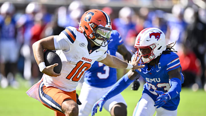 Oct 4, 2025; Dallas, Texas, USA; Syracuse Orange quarterback Rickie Collins (10) stiff arms SMU Mustangs safety Isaiah Nwokobia (23) during the first half at Gerald J. Ford Stadium. Mandatory Credit: Jerome Miron-Imagn Images