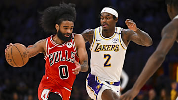 Mar 22, 2025; Los Angeles, California, USA; Chicago Bulls guard Coby White (0) drives the ball against Los Angeles Lakers forward Jarred Vanderbilt (2) during the second half at Crypto.com Arena. Mandatory Credit: Jonathan Hui-Imagn Images