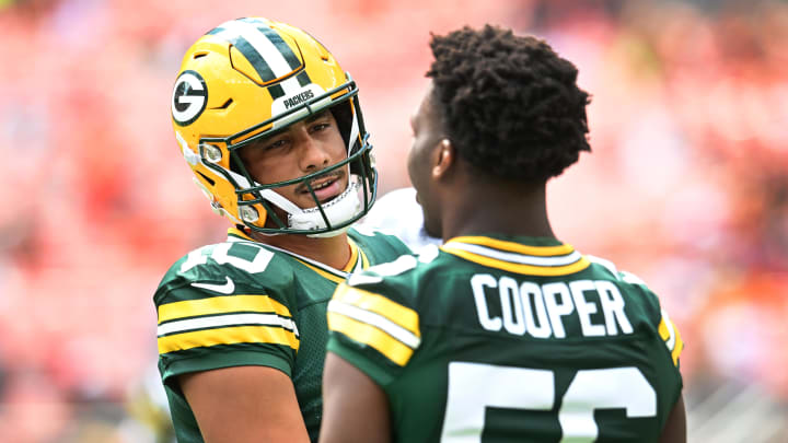 Green Bay Packers quarterback Jordan Love (10) talks to  linebacker Edgerrin Cooper before the preseason game against the Cleveland Browns.