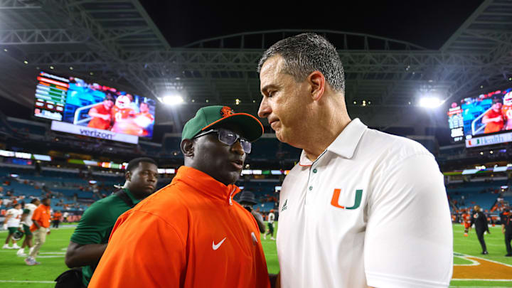 Sep 7, 2024; Miami Gardens, Florida, USA; Miami Hurricanes head coach Mario Cristobal and Florida A&M Rattlers head coach James Colzie III shake hands after the game at Hard Rock Stadium. Mandatory Credit: Sam Navarro-Imagn Images