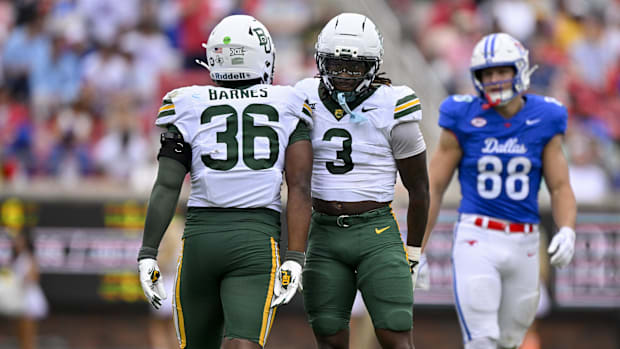Baylor Bears linebacker Travion Barnes (36) and safety Devyn Bobby (3) look on