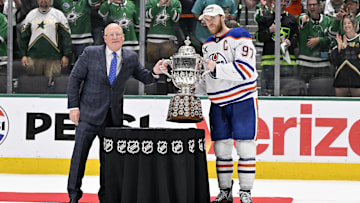 NHL deputy commissioner Bill Daly and Edmonton Oilers center Connor McDavid pose with the trophy after winning the Western Conference Final of the 2025 Stanley Cup Playoffs.