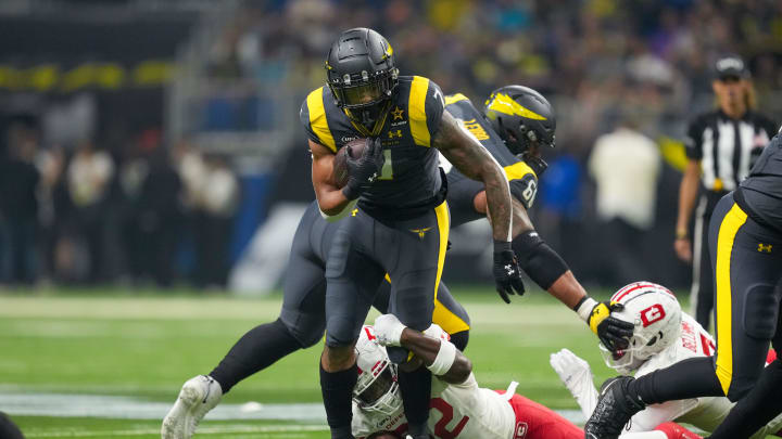 Mar 31, 2024; San Antonio, TX, USA;  San Antonio Brahmas running back John Lovett (7) runs the ball as DC Defenders defensive end Malik Fisher (92) grabs his ankle in the first half at The Alamodome. Mandatory Credit: Daniel Dunn-USA TODAY Sports