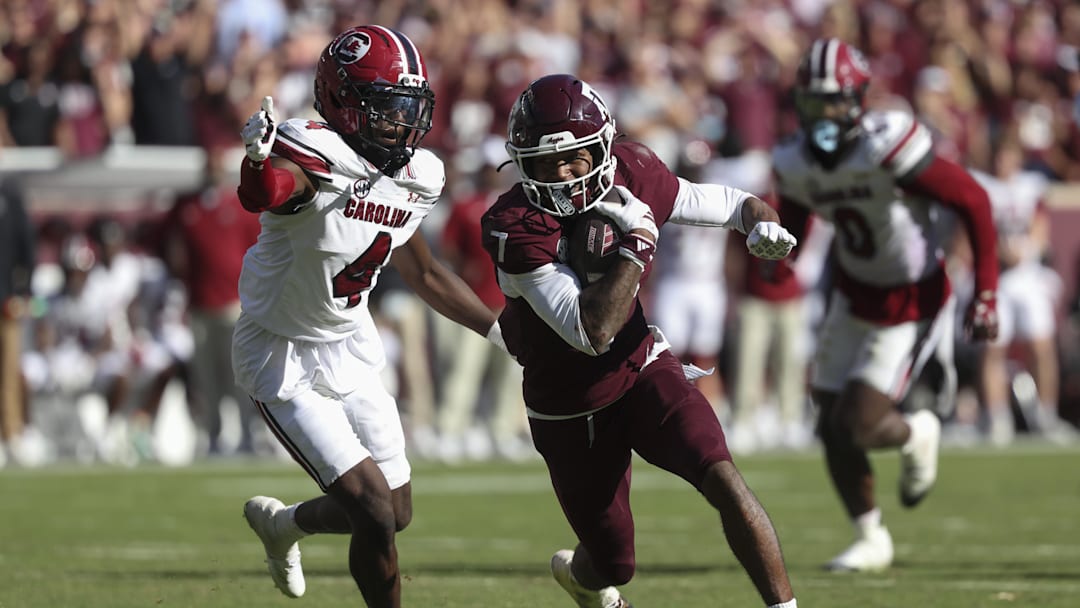 Nov 15, 2025; College Station, Texas, USA; Texas A&M Aggies wide receiver KC Concepcion (7) runs with the ball past South Carolina Gamecocks defensive back Vicari Swain (4) during the fourth quarter at Kyle Field. Mandatory Credit: Troy Taormina-Imagn Images