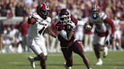 Nov 15, 2025; College Station, Texas, USA; Texas A&M Aggies wide receiver KC Concepcion (7) runs with the ball past South Carolina Gamecocks defensive back Vicari Swain (4) during the fourth quarter at Kyle Field. Mandatory Credit: Troy Taormina-Imagn Images