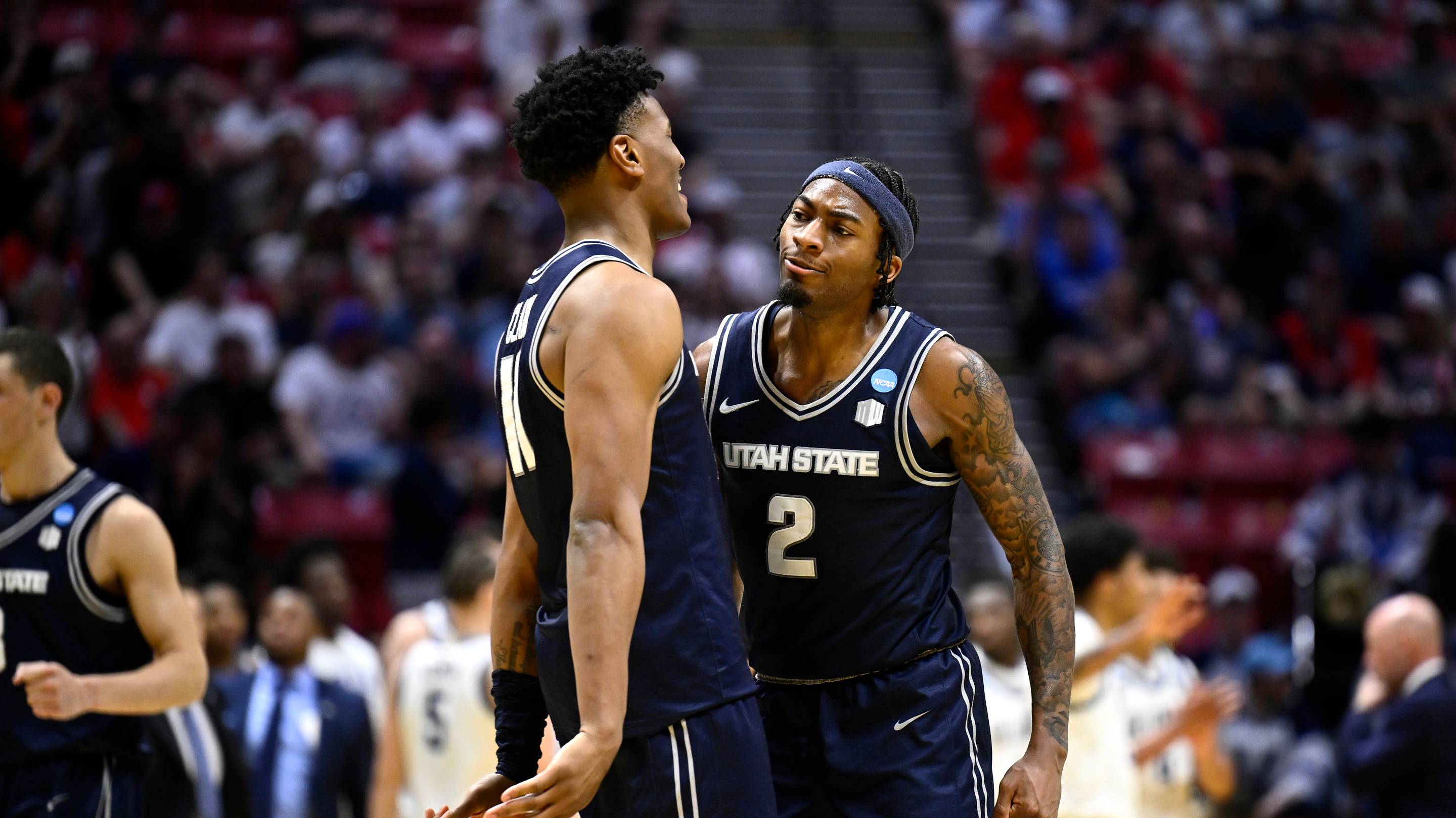 Mar 20, 2026; San Diego, CA, USA; Utah State Aggies guard Mj Collins (2) reacts with forward Garry Clark (11) in the second half against the Villanova Wildcats during a first round game of the men's 2026 NCAA Tournament at Viejas Arena. Mandatory Credit: Denis Poroy-Imagn Images | IMAGN IMAGES via R