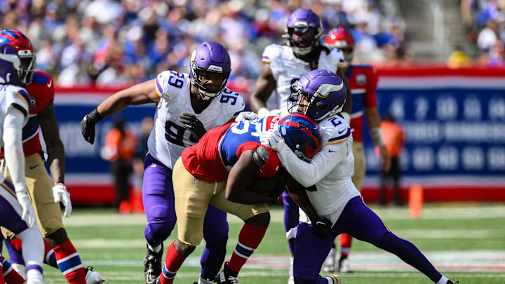 Sep 8, 2024; East Rutherford, New Jersey, USA; New York Giants running back Devin Singletary (26) carries the ball as Minnesota Vikings wide receiver Stephon Gilmore (2) makes the tackle during the second half at MetLife Stadium.  