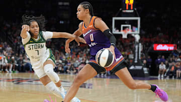 Jun 7, 2025; Phoenix, Arizona, USA; Phoenix Mercury forward Satou Sabally (0) drives on Seattle Storm guard Zia Cooke (7) in the second half at Footprint Center. Mandatory Credit: Rick Scuteri-Imagn Images