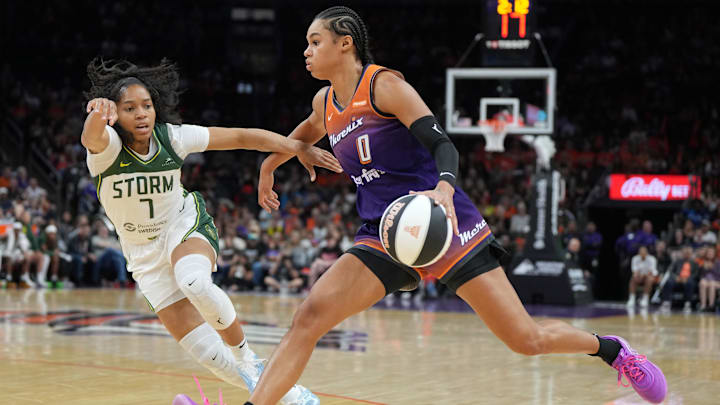 Jun 7, 2025; Phoenix, Arizona, USA; Phoenix Mercury forward Satou Sabally (0) drives on Seattle Storm guard Zia Cooke (7) in the second half at Footprint Center. Mandatory Credit: Rick Scuteri-Imagn Images