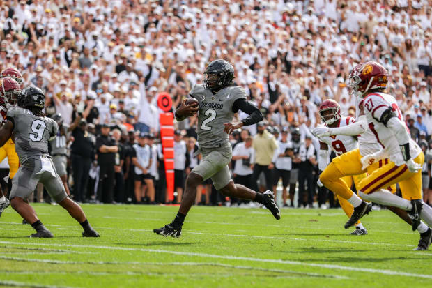 Colorado Buffaloes quarterback Shedeur Sanders runs for a touchdown.