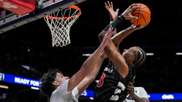 Dec 5, 2025; Cincinnati, Ohio, USA;  Cincinnati Bearcats forward Baba Miller (18) drives to the basket against Xavier Musketeers forward Jovan Milicevic (24) and forward Pape N'Diaye (22) in the second half at the Cintas Center. Mandatory Credit: Aaron Doster-Imagn Images