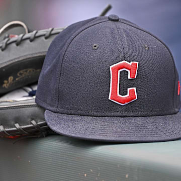 Jun 27, 2024; Kansas City, Missouri, USA; A general view a Cleveland Guardians hat and glove on the dugout railing  before a game against the Kansas City Royals at Kauffman Stadium.