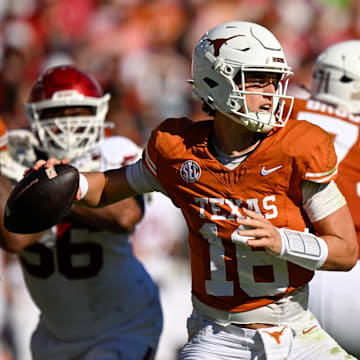 Texas Longhorns quarterback Arch Manning looks to throw the ball during the game between the Texas Longhorns and the Oklahoma Sooners at the Cotton Bowl.