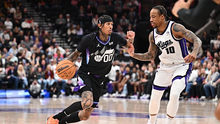 Feb 26, 2025; Salt Lake City, Utah, USA;  Utah Jazz guard Jordan Clarkson (00) controls the ball while being guarded by Sacramento Kings guard DeMar DeRozan (10) in the second half at Delta Center. Mandatory Credit: Jamie Sabau-Imagn Images
