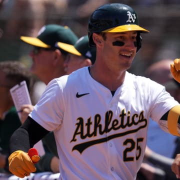 Jun 9, 2024; Oakland, California, USA; Oakland Athletics designated hitter Brent Rooker (25) is congratulated by teammates after hitting a home run against the Toronto Blue Jays during the sixth inning at Oakland-Alameda County Coliseum. Mandatory Credit: Darren Yamashita-USA TODAY Sports