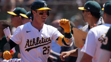 Jun 9, 2024; Oakland, California, USA; Oakland Athletics designated hitter Brent Rooker (25) is congratulated by teammates after hitting a home run against the Toronto Blue Jays during the sixth inning at Oakland-Alameda County Coliseum. Mandatory Credit: Darren Yamashita-USA TODAY Sports