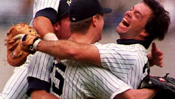 New York Yankees pitcher Jim Abbott (C) is grabbed