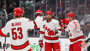 Oct 26, 2024; Seattle, Washington, USA; Carolina Hurricanes right wing Jackson Blake (53) and left wing William Carrier (28) and center Jack Drury (18) celebrate after a goal scored by Drury during the second period against the Seattle Kraken at Climate Pledge Arena. Mandatory Credit: Steven Bisig-Imagn Images