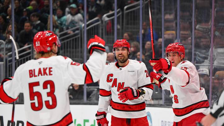 Oct 26, 2024; Seattle, Washington, USA; Carolina Hurricanes right wing Jackson Blake (53) and left wing William Carrier (28) and center Jack Drury (18) celebrate after a goal scored by Drury during the second period against the Seattle Kraken at Climate Pledge Arena. Mandatory Credit: Steven Bisig-Imagn Images