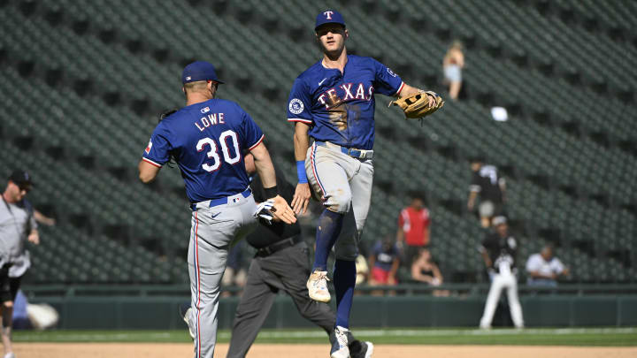 Aug 29, 2024; Chicago, Illinois, USA;  Texas Rangers first baseman Nathaniel Lowe (30) and third baseman Josh Jung (6) celebrate after the game against the Chicago White Sox at Guaranteed Rate Field. Mandatory Credit: Matt Marton-USA TODAY Sports