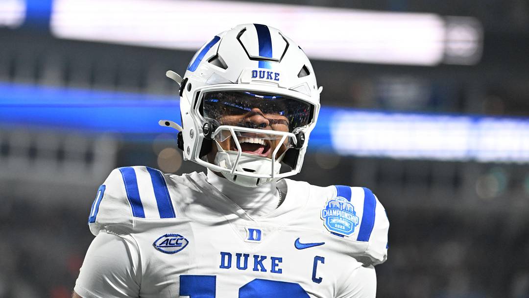 Dec 6, 2025; Charlotte, NC, USA; Duke Blue Devils quarterback Darian Mensah (10) celebrates after the Blue Devils score a touchdown in overtime during the  ACC Championship game at Bank of America Stadium. Mandatory Credit: Bob Donnan-Imagn Images