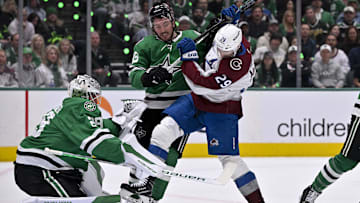 Apr 21, 2025; Dallas, Texas, USA; Dallas Stars center Matt Duchene (95) checks Colorado Avalanche center Nathan MacKinnon (29) in front of goaltender Jake Oettinger (29) during the first period in game two of the first round of the 2025 Stanley Cup Playoffs at American Airlines Center. Mandatory Credit: Jerome Miron-Imagn Images