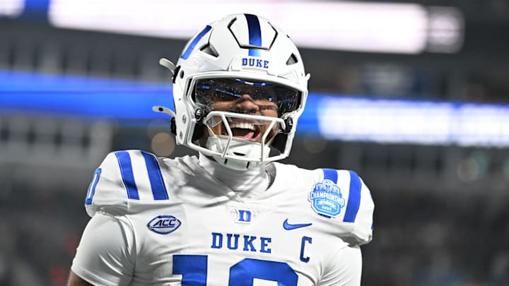 Dec 6, 2025; Charlotte, NC, USA; Duke Blue Devils quarterback Darian Mensah (10) celebrates after the Blue Devils score a touchdown in overtime during the  ACC Championship game at Bank of America Stadium. Mandatory Credit: Bob Donnan-Imagn Images
