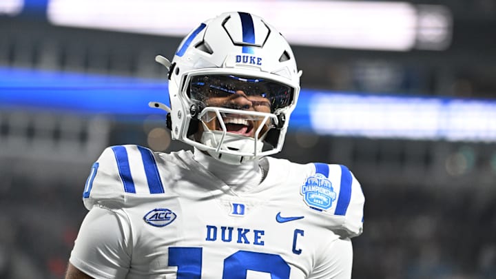 Dec 6, 2025; Charlotte, NC, USA; Duke Blue Devils quarterback Darian Mensah (10) celebrates after the Blue Devils score a touchdown in overtime during the  ACC Championship game at Bank of America Stadium. Mandatory Credit: Bob Donnan-Imagn Images
