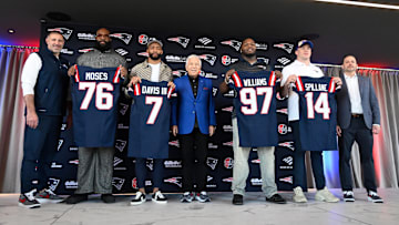 Mar 13, 2025; Foxborough, MA, USA; The New England Patriots hold a press conference at the GP Atrium at Gillette Stadium to introduce free agency additions to the team. (Left to right) New England Patriots head coach Mike Vrabel, offensive tackle Morgan Moses, cornerback Carlton Davis III, owner Robert Kraft, defensive tackle Milton Williams, linebacker Robert Spillane and executive vice president of player personnel Eliot Wolf. Mandatory Credit: Eric Canha-Imagn Images