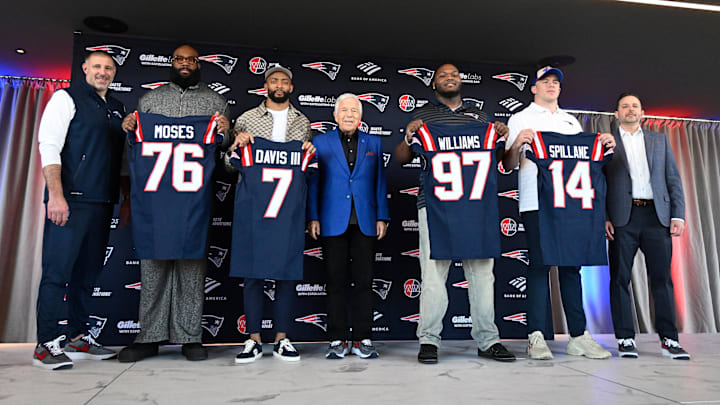 Mar 13, 2025; Foxborough, MA, USA; The New England Patriots hold a press conference at the GP Atrium at Gillette Stadium to introduce free agency additions to the team. (Left to right) New England Patriots head coach Mike Vrabel, offensive tackle Morgan Moses, cornerback Carlton Davis III, owner Robert Kraft, defensive tackle Milton Williams, linebacker Robert Spillane and executive vice president of player personnel Eliot Wolf. Mandatory Credit: Eric Canha-Imagn Images