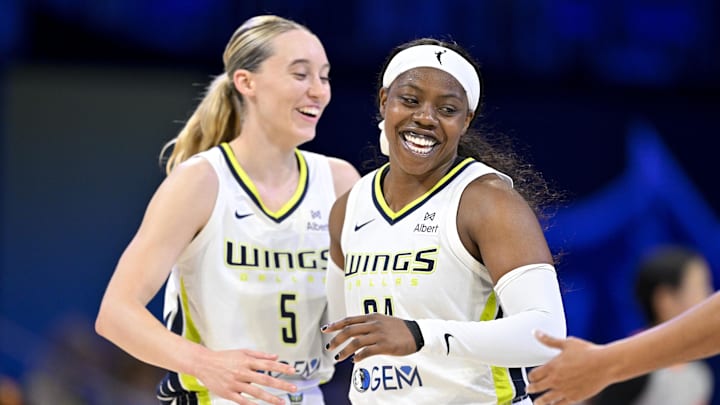 Jul 28, 2025; Arlington, Texas, USA; Dallas Wings guard Paige Bueckers (5) and guard Arike Ogunbowale (24) celebrate during the second half against the New York Liberty at College Park Center. Mandatory Credit: Jerome Miron-Imagn Images