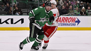 Jan 19, 2025; Dallas, Texas, USA; Dallas Stars defenseman Miro Heiskanen (4) and Detroit Red Wings right wing Jonatan Berggren (48) chase the puck during the third period at the American Airlines Center. Mandatory Credit: Jerome Miron-Imagn Images