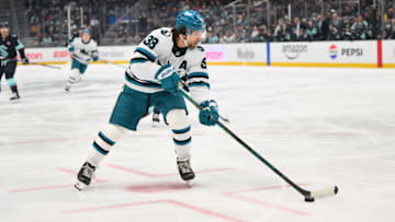 Jan 30, 2025; Seattle, Washington, USA; San Jose Sharks defenseman Mario Ferraro (38) plays the puck during the first period against the Seattle Kraken at Climate Pledge Arena. Mandatory Credit: Steven Bisig-Imagn Images